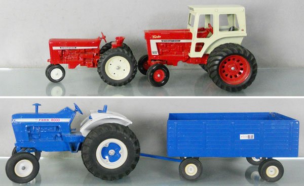3 ERTL TRACTORS: die cast, Ford Tractor & Trailer, 2 International Tractors, missing 1 rubber exhaust pipe, C8.