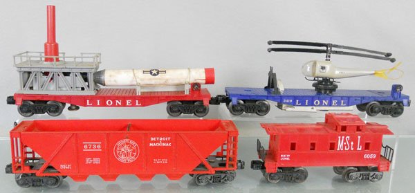 4 LIONEL FREIGHT CARS: O ga, 3413 Mercury Capsule Launching Car, handrails broken, missile cracked, 3419 helicopter car, 6736 hopper, 6059 M&StL caboose, C6-8.