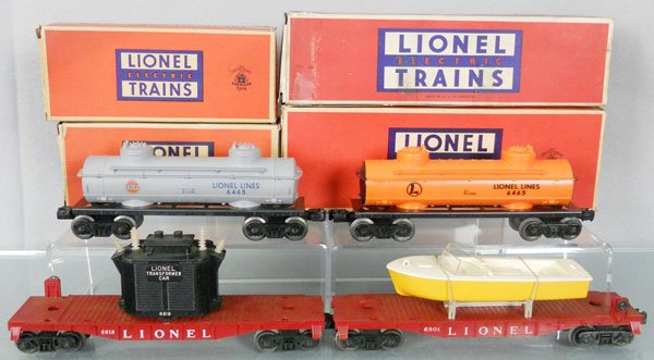 4 LIONEL FREIGHT CARS: O ga, 6465 Gulf tank, 6465 tank, 6818 transformer car, 1 insulator is reglued, 6801 flat w/boat, orig boxes, 2 worn, 1 has tape, C7-8.