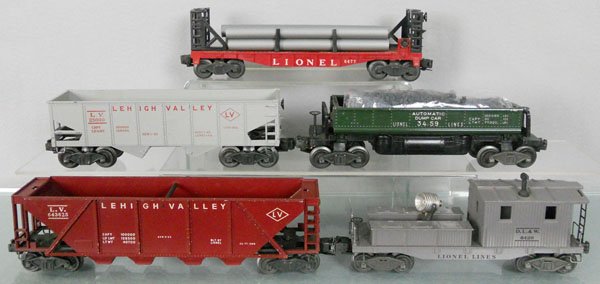 5 LIONEL FREIGHT CARS: O ga, 6477 flat w/pipes, 6456 LV hopper, 3459 dump, 6436 LV hopper, 6420 work caboose, C5-7.
