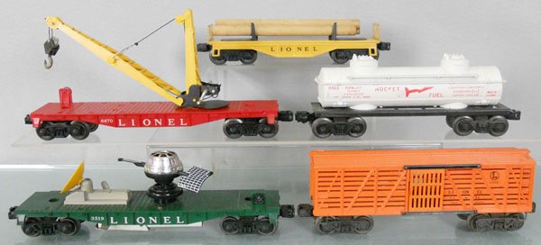 5 LIONEL FREIGHT CARS: O ga, 6111 log car, 6670 boom car, 6463 rocket fuel car, 3519 satellite launching car, 6646 stock car, C6-7.