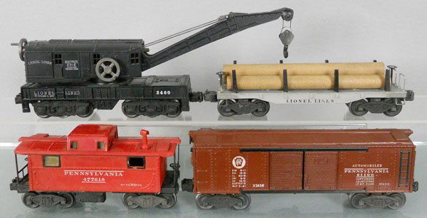 4 LIONEL FREIGHT CARS: O ga, 2460 crane, 2411 flat w/logs, 2457 caboose, roof repainted, 2458 PRR auto box car, C6-7.