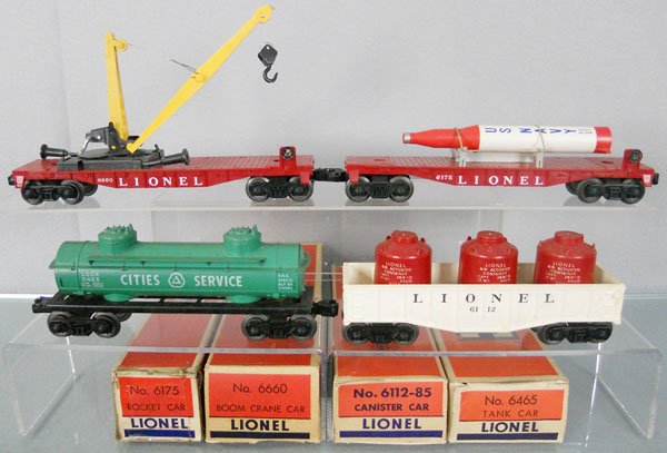 4 LIONEL FREIGHT CARS: O ga, 6660 boom crane, 6175 rocket car, 6465 Cities Service tanker, 6112 gondola w/canisters, orig boxes worn, 1 incom & taped, C6-7.