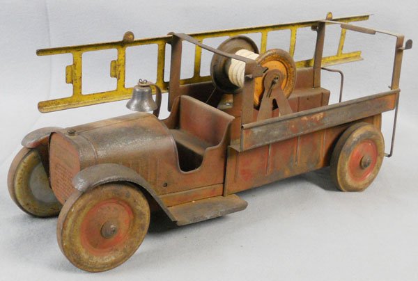 STRUCTO FIRE ENGINE: pressed steel, 18" long, missing 1 ladder, paint oxidized, C2.