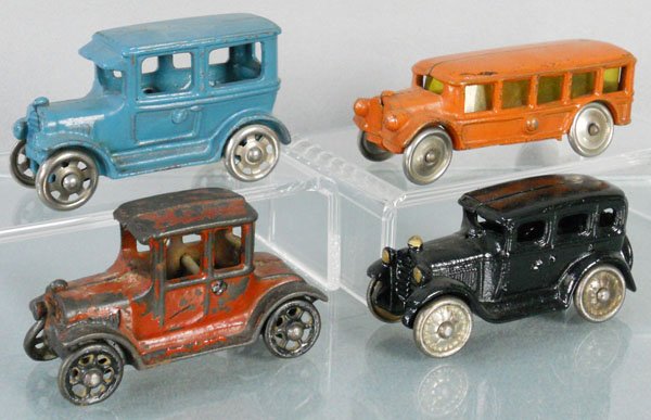 4 TOY AUTOS: painted cast iron, Hubley Sedan, 4" long, AC Williams Bus, 5" long, Hubley Coupe, 4" long, AC Williams Sedan, 4" long, repainted, C2-5.
