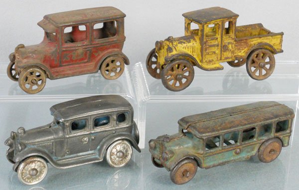 4 TOY VEHICLES: painted cast iron, Hubley Sedan, 4" long, Hubley Huckster, 4 3/4" long, AC Williams Sedan, 4" long, AC Williams Bus, 5" long, C1-3.
