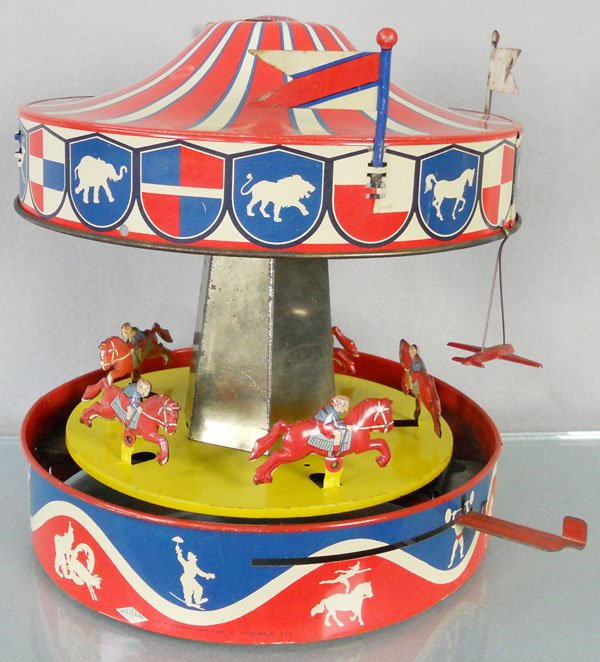 WOLVERINE MERRY-GO-ROUND: litho tin, working, 12" tall, missing 1 flag & 3 airplanes, C6.