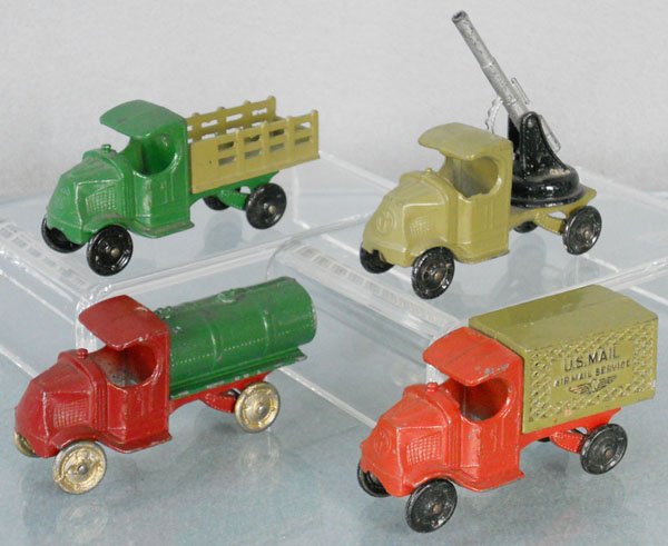 4 TOOTSIETOY MACK TRUCKS: 4638 Stake Truck, 4643 AA Gun, 4640 Tanker, small dent on 1 side, 4654 US Mail, C5-6.