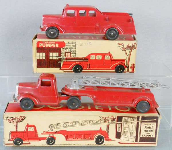 2 TOOTSIETOY FIRE VEHICLES: 469 Pumper, 6 1/4" long, missing hoses on 1 side, 489 Aerial Hook & Ladder, 9" long, orig boxes have some wear, C7.