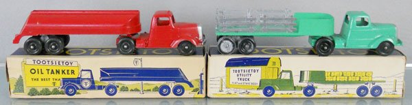2 TOOTSIETOY MACK TRUCKS: 669 Oil Tanker, 9" long, casting flaw at rear of tank, orig box minor wear, missing 1 end flap, 869 Utility Truck Flat & Stake Body, 9" long, orig box minor wear, missing piece of end flap, C8.