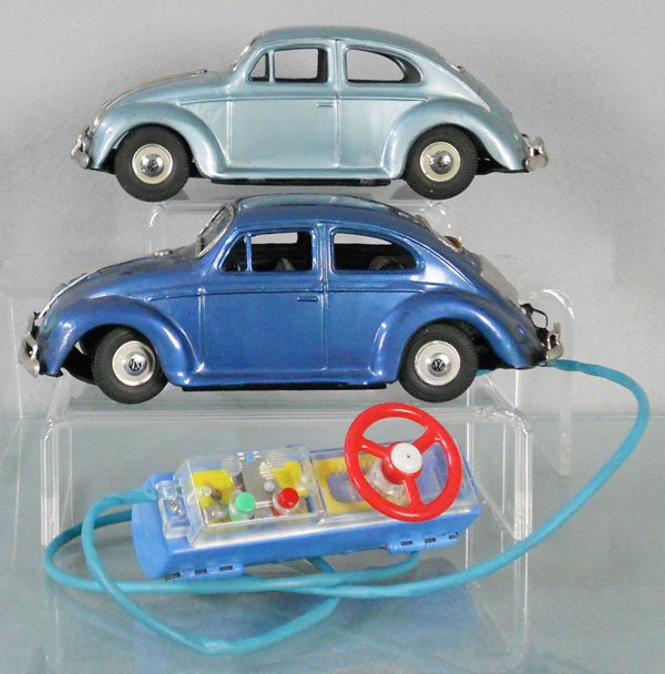 2 SKK VOLKSWAGEN BEETLES: Japan, litho tin, light blue, friction not working, dark blue, battery operated w/remote control, not tested, battery box clean, both are 8" long, playwear, some oxidation on some trim pieces, C5.