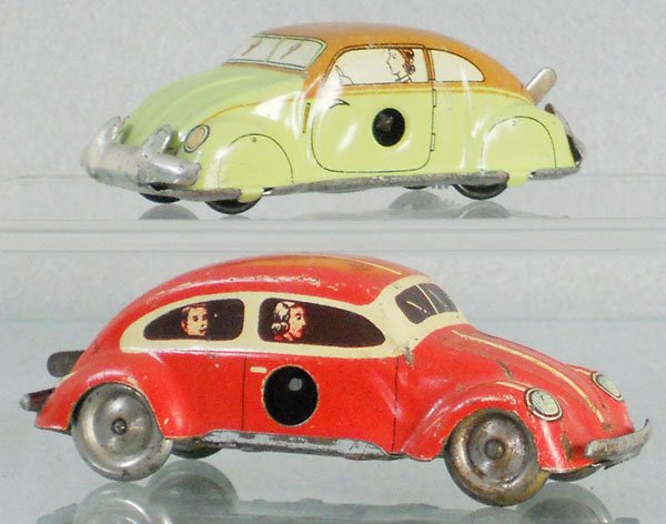 2 VOLKSWAGEN BEETLES: litho tin, windup working, Tippco, red, 3 1/2" long, Huki, green, 3" long, both are split window, C5-6.