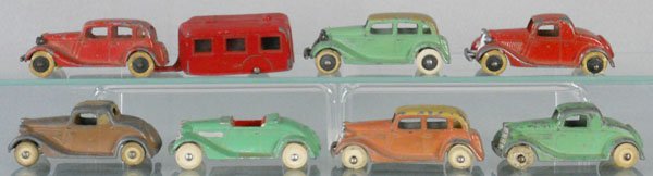 7 TOOTSIETOY FORDS: 111 Sedan w/trailer, 2 #115 Convertible Sedans, 2 #112 Coupes, 114 Convertible Coupe, 116 Roadster, w/painted embellishment, missing 1 headlight, C3-5.