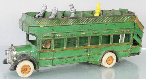 ARCADE DOUBLEDECKER BUS: painted cast iron, 13 1/2" long, rubber tires worn, missing 4 seats on top deck, rear steps are original, 1" crack behind driver's side rear wheel, w/6 reproduction passengers, C5.