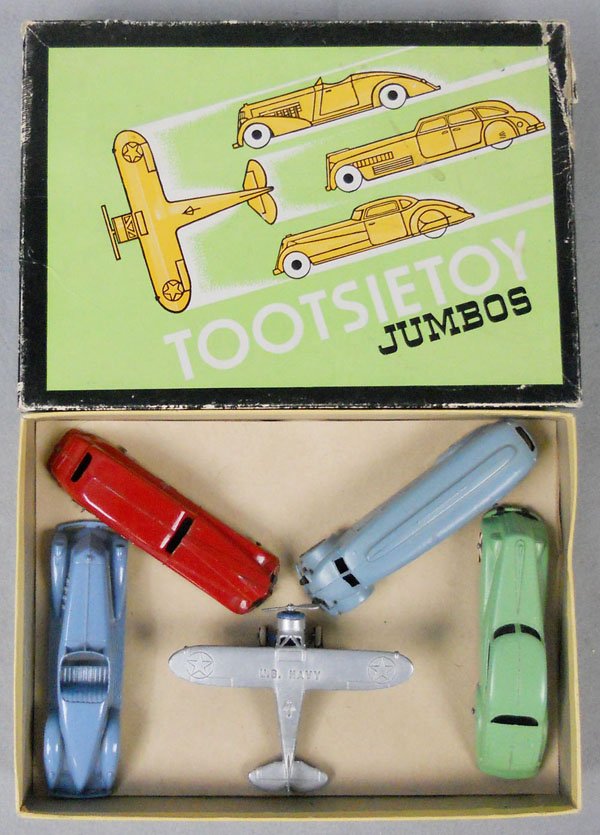 TOOTSIETOY 750 JUMBOS SET: contains 1016 Speedster, 1018 Sedan, 1045 Greyhound Bus, 1017 Coupe, 3 have a tin chassis, 718 US Navy Plane, orig set box & insert minor wear, C9.
