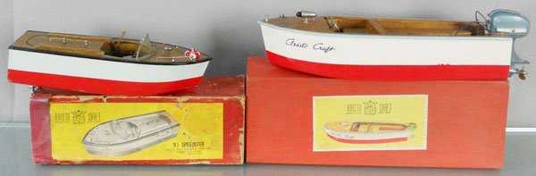 2 ARISTO CRAFT BOATS: wooden, 1 is 12" long w/metal outboard motor, other is 9 1/2" long, missing a rudder, orig boxes, 1 minor wear, 1 worn, C8.