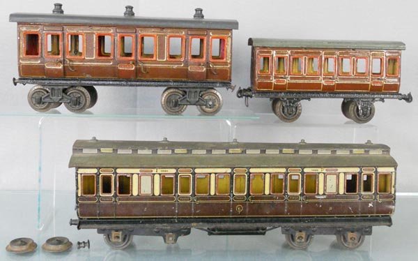 3 BING ENGLISH PASSENGER CARS: 1 ga, handpainted tin, 3rd Class coach w/interior, 11 1/2" long, 3rd Class coach, 9 1/4" long, 1324 coach, 16" long, lot missing 3 buffers, an axle & 7 journal boxes, 2 couplers broken, C4-5.