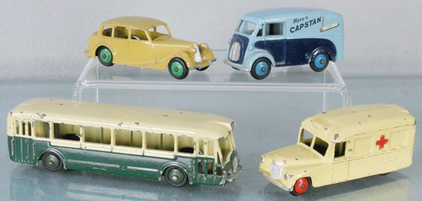 4 DINKY VEHICLES: 40B Triumph 1800, rust spot on trunk, 465 Morris Capstan Van, light decal wear on 1 side, chip on 1 side, C6, 253 Daimler Ambulance, chipped, FR29D Paris Bus, chipped, C4-5.