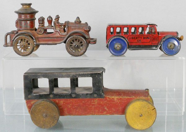 3 TOY VEHICLES: AC Williams Fire Pumper, painted cast iron, 6 1/4” long, oxidation spots, Marx Bus, litho tin, 5” long, missing motor, Auto, wooden, 8” long, w/house paint overspray, C4.