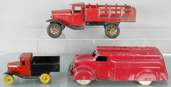 3 WYANDOTTE TRUCKS: painted pressed steel, Stake Truck, 9 1/2” long, worn rubber tires, oxidation on hubs, Tanker, 10 1/2” long, missing rear door, tires worn, Pick Up, 5 1/2” long, C4-5.