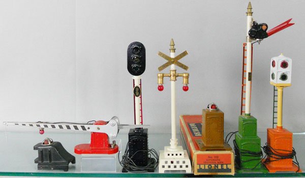 7 LIONEL ACCESSORIES: std ga, 025 bumper, 152 crossing gate, orig box worn, 99 traffic signal, 79 railroad crossing signal, 91 circuit breaker, 82 semaphore, 78 traffic signal, all except for the bumper & crossing gate are