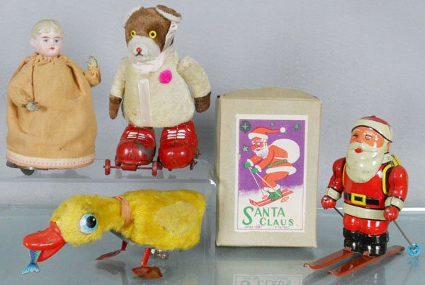 4 WINDUP TOYS: Duck, 7 1/2” long, windup working, Rollerskating Bear, Japan, friction not working, Skiing Santa Claus, Japan, windup not working, 5 3/4” tall, orig box some wear, Girl Doll, bisque head, tin hand