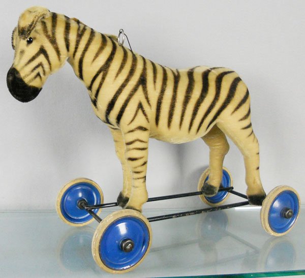STEIFF ZEBRA ON WHEELS: button in ear, mane trimmed, voice box not working, 22” long, C6.