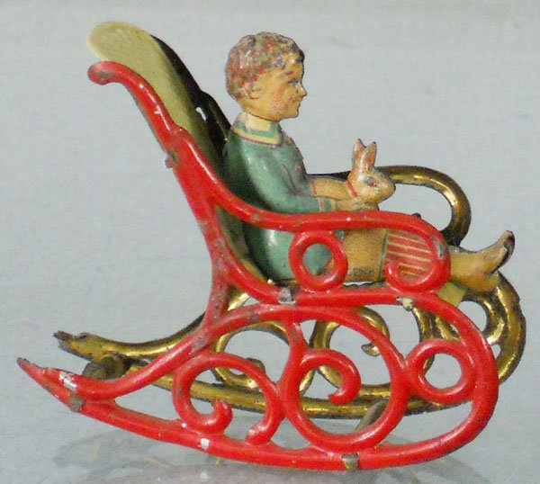MEIER BOY W/RABBIT IN ROCKING CHAIR PENNY TOY: litho tin, 2 3/4” long, C6.