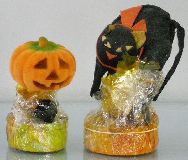 2 HALLOWEEN CANDY CONTAINERS: Pumpkin, 4” tall, Black Cat, 5” tall, semi-sealed w/candy, C6-7.