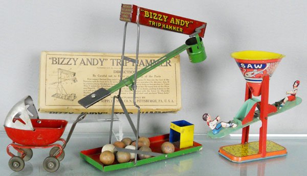 3 TIN TOYS: litho tin, Wolverine Bizzy Andy Trip Hammer, w/marbles, 11" tall, orig box minor wear, Wyandotte Carriage, 5" long, Chein See Saw Sand Toy, 7" tall, C6-7.