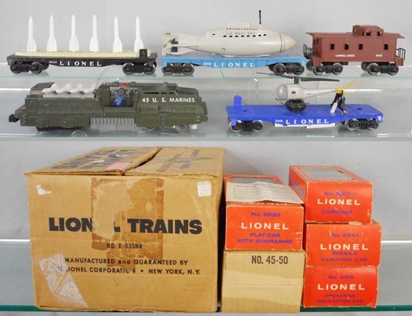 LIONEL X-535NA TRAIN SET: O ga, 45 Marine loco, 1 step broken, 3419 flat w/helicopter, 6844 missile transport, 6830 flat w/submarine, 6017 caboose, orig boxes have new plastic windows, orig set box minor wear, C6-7.