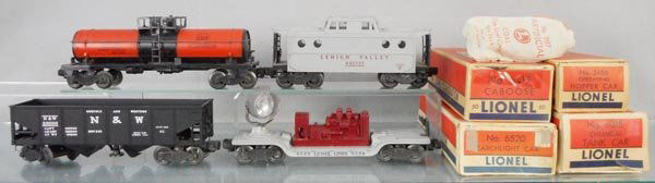 4 LIONEL FREIGHT CARS: O ga, 6315 tank, 6417-50 caboose, 3456 hopper, 6520 searchlight, orig boxes some wear, 2 taped, C6-7.