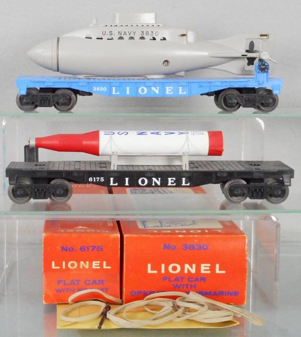 2 LIONEL FREIGHT CARS: O ga, 3830 flat w/submarine, 6175 flat w/rocket, orig boxes minor wear, C8-9.