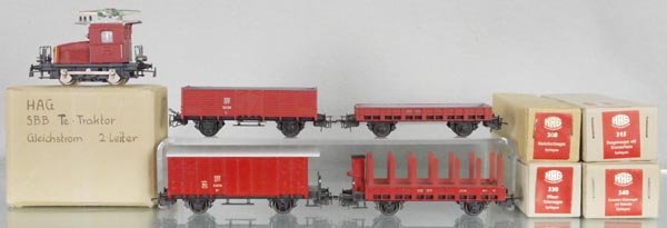 HAG FREIGHT TRAIN SET: HO ga, 2-rail, 131 TE101 loco, 300 flat car, brown, 315 stake car w/house, brown, 340 box car, brown, 330 hopper, brown, orig boxes, 2 w/graffiti, C9-10.