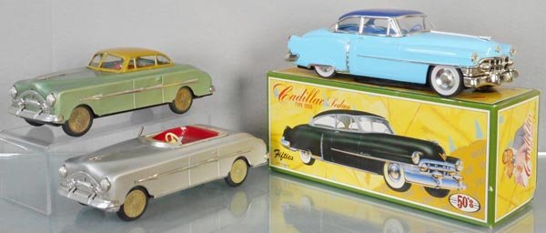 3 TIN AUTOS: 11 " long, 2 Packards, made in Hungary, 1950 Cadillac, made in Japan, all are friction working, 1 orig box only, C7-10.