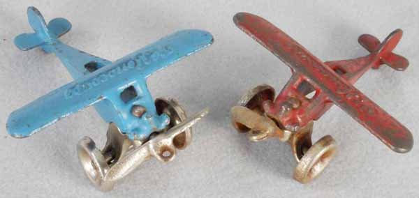 2 ARCADE “THE MONOCOUPE” AIRPLANES: painted cast iron, 3 3/4” wingspan, 1 has a broken propeller, C4-5.