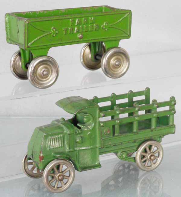 2 CAST IRON VEHICLES: painted cast iron, Kenton Farm Trailer, 4 1/2” long, Hubley Mack Truck, 5 1/2” long, C5.