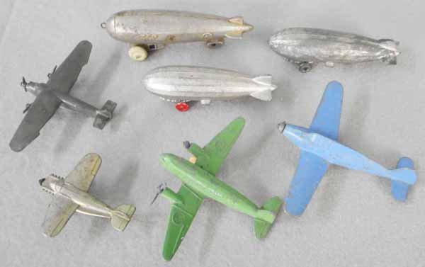 7 SLUSH DIE CAST AIRPLANES: 3 Zeppelins, 4” to 4 3/4” long, 4 Airplanes, 2 1/2” to 4 1/2” wingspans, 3 have broken propellers, C3-5.