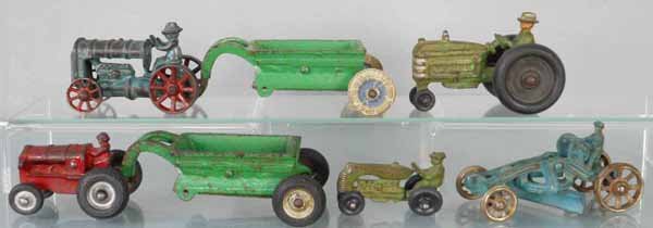 6 FARM TOYS: painted cast iron, Hubley Tractor, 3 1/2” long, 2 Arcade Trailers, 5 1/2” long, Hubley Tractor, 4” long, Arcade Tractor, 3” long, Hubley Tractor, 2 3/4” long, AC Williams Grader, 4 1/4” lo