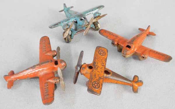 4 TOY AIRPLANES: painted cast iron, 2 Arcade Boeing United Planes, 4 3/4” wingspans, 1 missing propellers & wheels, Hubley Trimotor, 4” wingspan, Hubley Monoplane, 3” wingspan, C4-5.