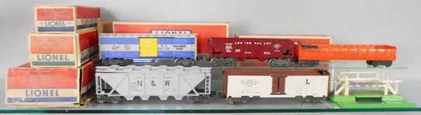 5 LIONEL FREIGHT CARS: O ga, 6464-150 Eagle box car, 6456 LV hopper, 3562-75 barrel loader w/accessories, 6446 N&W hopper, 3662 milk car & platform, platform tarnished, orig boxes worn or rough, C5-7.