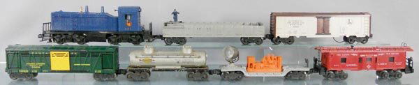 LIONEL TRAIN SET: O ga, 621 Jersey Central switcher, screw crack & glue residue on front, 3562-25 barrel car, 3662 milk car, 3356 horse car, 6465 tank, 6520 searchlight car, oxidation spots, 6517 caboose, C5.