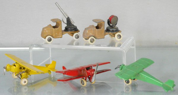 5 TOOTSIETOY VEHICLES: 4660 Aero-Dawn Monoplane, 4649 Ford TriMotor, 4643 Mack Anti Aircraft Gun Truck, new tires, 4644 Mack Searchlight Truck, new tires, Bi-Wing Monoplane, C4-5.