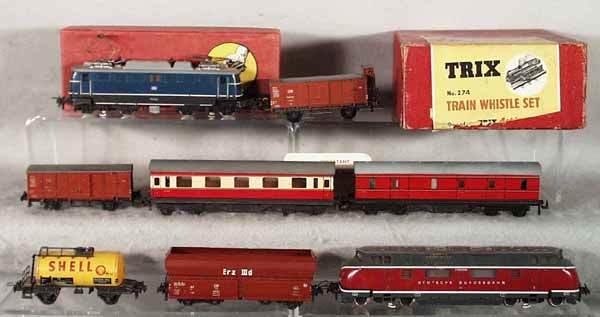 TRIX TRAIN LOT: HO ga, TE 2243 loco, 2-rail, ob minor wear; 20/118 box car; 274 train whistle set, ob minor wear; 20/117 box car; coach; TE427 tank; TE486 hopper; TE764 loco, 3-rail; most cars missing wire part of co