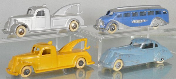 4 TOOTSIETOY JUMBOS: 2 #1027 Wrecker, 1045 Greyhound bus, 1017 Coupe, 2 tires flat, C5-7.