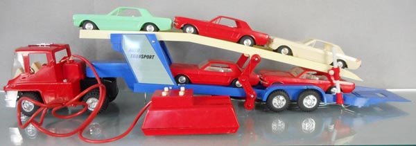 SEARS AUTO TRANSPORT: plastic, 26 1/2” long, battery operated, partially working, w/5 Mustangs, each 7 1/4” long, all cars are damaged and/or incom, truck cab has melt marks, orig box worn, C6.
