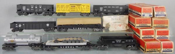 8 LIONEL FREIGHT CARS: O ga, 3456 hopper, 6656 stock, 6456 hopper, 6462 gondola, 6424 flat w/autos, 6465 tank, 6262 flat w/wheels, 3469 dump car, orig boxes minor wear, 3 worn, C6-8.