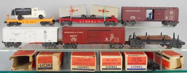 6 LIONEL FREIGHT CARS: O ga, 6151 flat w/Range Patrol truck, 6430 flat w/trailers, 3484 PRR box car, 6472 milk car, 6464-50 M&StL box car, 3461 log car, orig boxes rough, C5-7.