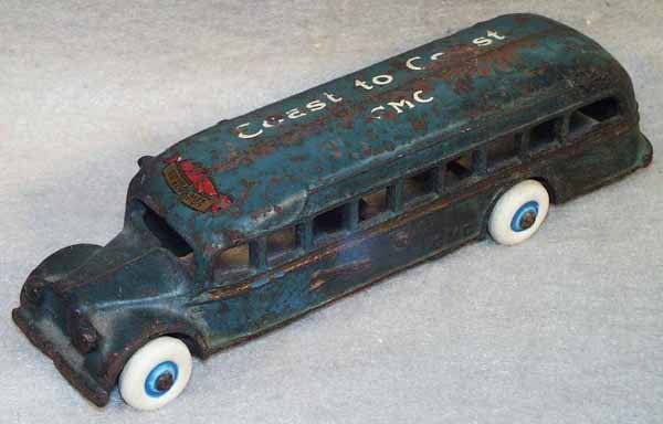 ARCADE GMC COAST TO COAST BUS: w/1937 Great Lakes Exposition decal on roof, painted cast iron, paint chipped, rubber tires replaced, 7.5" long, C4. Complete information covering terms, conditions, payment and shipping is listed bel