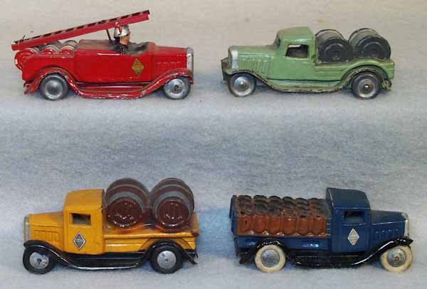 4 CIJ RENAULT TRUCKS: painted die cast w/tin chassis, 2 have rubber tires, some paint flaking, Fire Truck, 4" long; Barrel Truck, 3.75" long; Cable Truck, 3.75" long; Pickup w/sacks, 3.75" long, C4-6. Complete information